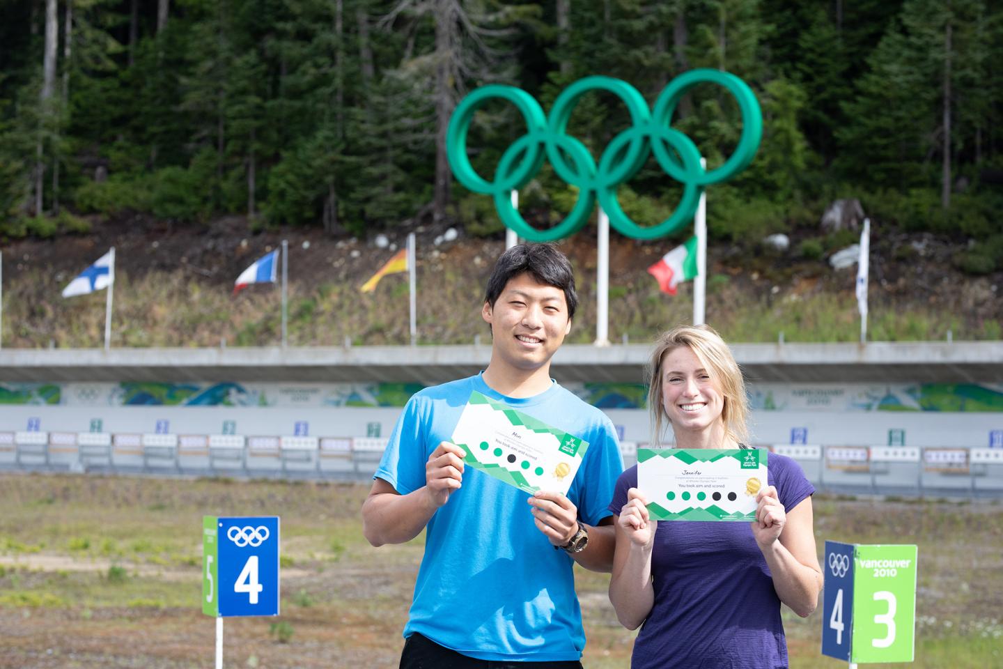 Two participants holding up completion certificates