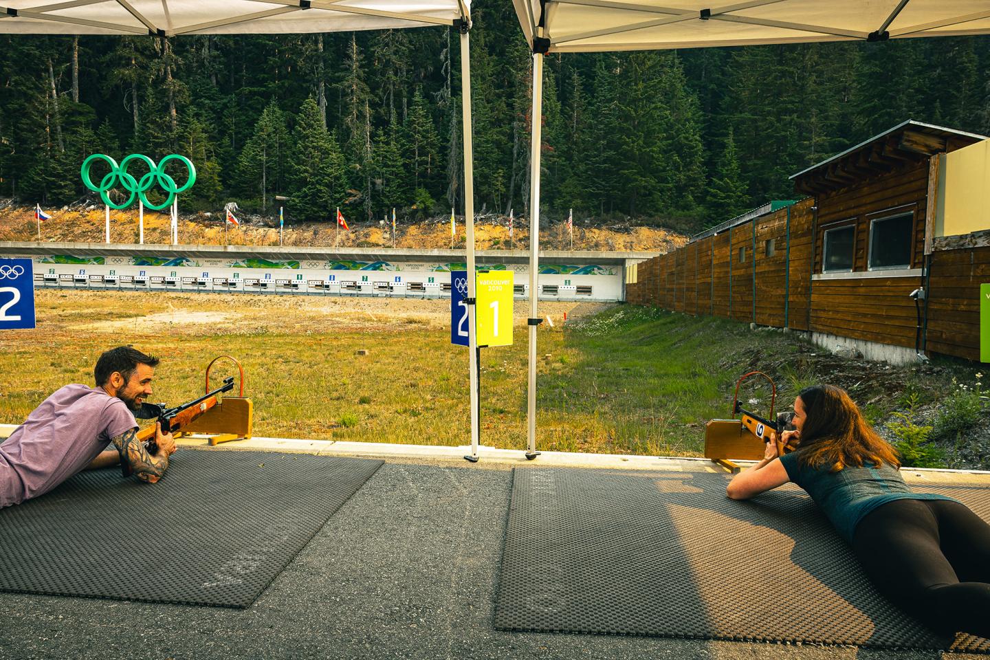 two people laying next to each other at biathlon shooting range